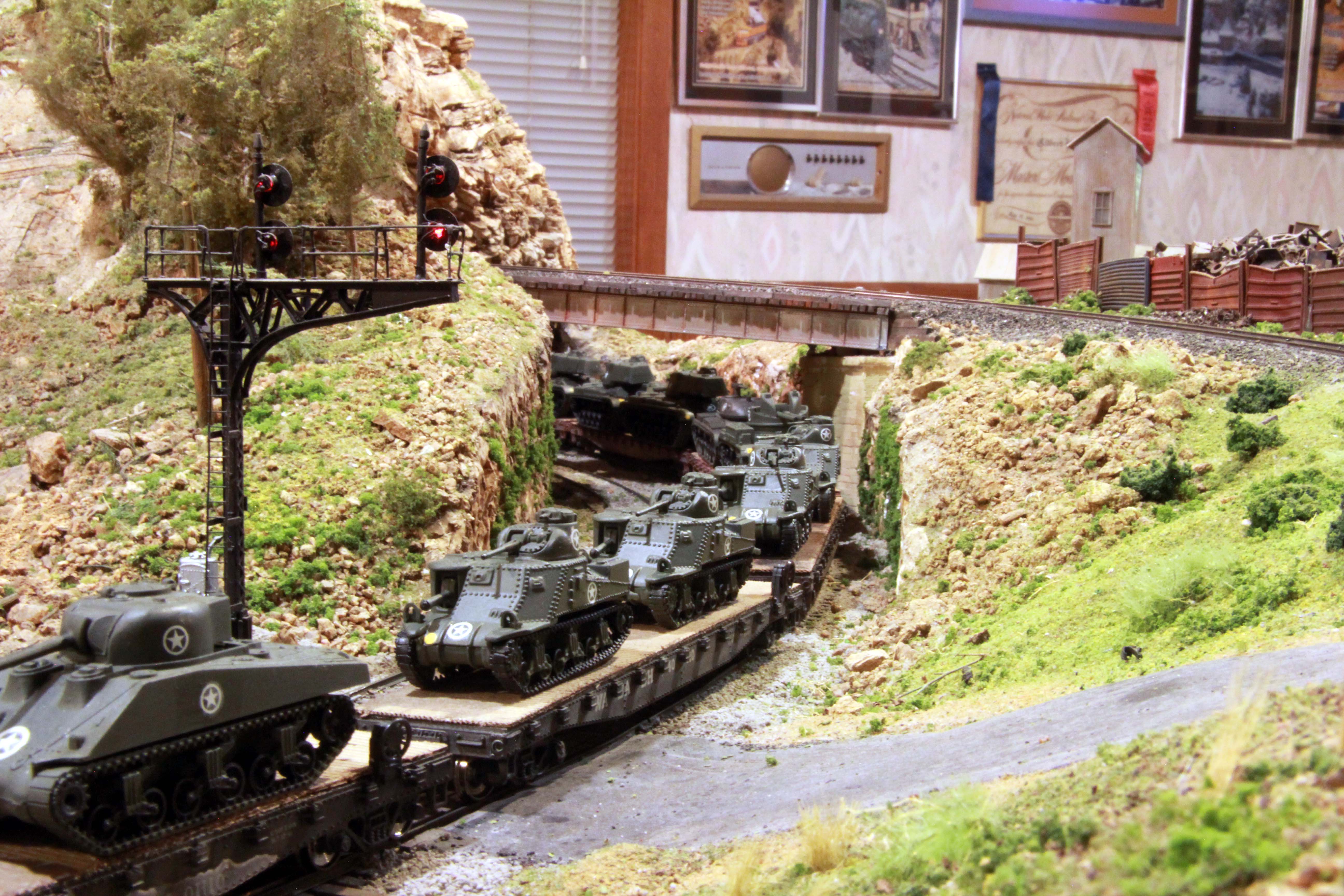 Mike Mackey's Military Train traveling through a canyon on the Stoney Creek & Western layout